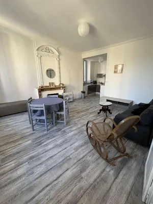 a living room with a couch and a table at Appartement in Limoux