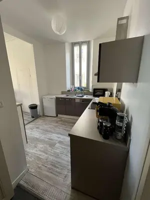 an empty kitchen with a counter and a sink at Appartement in Limoux