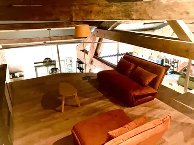 a living room with a couch and a chair at Vignerone atypique proche du canal du midi à 30 min des plages in Capestang
