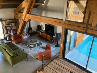 an overhead view of a living room with a table and chairs at Vignerone atypique proche du canal du midi à 30 min des plages in Capestang