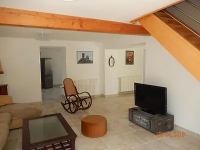 a living room with a couch and a television at GITE Le calme de la campagne plus le confort in Viviès