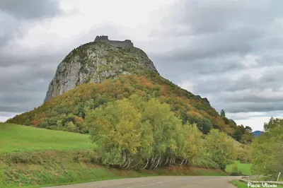 a mountain with a castle on top of it at GITE Le calme de la campagne plus le confort in Viviès