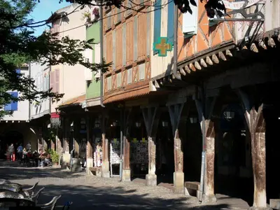 a group of buildings on a street with people sitting at GITE Le calme de la campagne plus le confort in Viviès