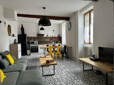 a living room with a couch and a table at La maison du pont vieux - emplacement de parking gratuit - Proche Cité médiévale in Carcassonne