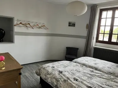 a bedroom with two beds and a desk and a window at La maison du pont vieux - emplacement de parking gratuit - Proche Cité médiévale in Carcassonne