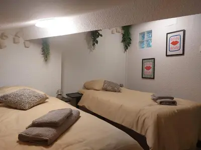 a room with two beds with towels on them at Appartement proche des Halles in Narbonne