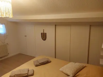 a bedroom with a bed with two towels on it at Appartement proche des Halles in Narbonne