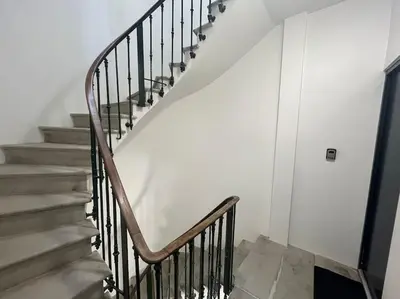 a staircase in a house with a metal railing at L'Ébène - Wifi - Proche des Halles et du centre ville in Narbonne
