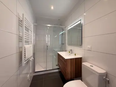 a bathroom with a toilet and a sink and a shower at L'Ébène - Wifi - Proche des Halles et du centre ville in Narbonne