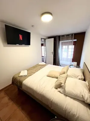 a bedroom with a large bed in a room at Les chambres de la bastide - 303 in Carcassonne