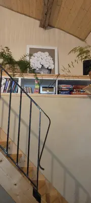 a staircase with a book shelf with books at le gîte du Cantou in Lautrec