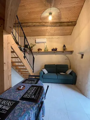 a living room with a blue couch and a table at le gîte du Cantou in Lautrec