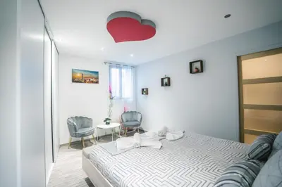 a bedroom with a bed with a red heart on the ceiling at La Pierre Dorée-3 chambre 2 salle de bain-AO in Puicheric