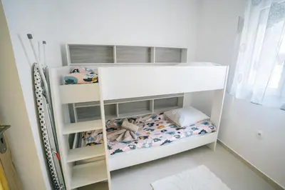 a white bunk bed in a small room at La Pierre Dorée-3 chambre 2 salle de bain-AO in Puicheric