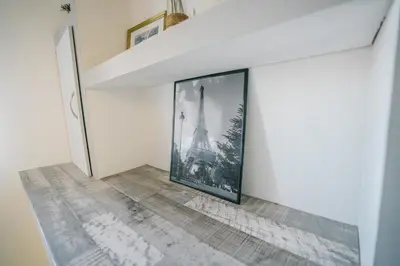 a hallway with a picture of the eiffel tower at La Pierre Dorée-3 chambre 2 salle de bain-AO in Puicheric