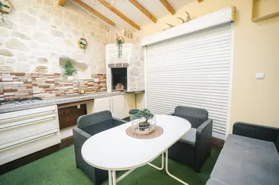 a kitchen with a white table and chairs at La Pierre Dorée-3 chambre 2 salle de bain-AO in Puicheric