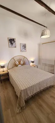 a bedroom with a large bed in a room at Le Marceau Terrasse Sur Le Toit in Narbonne