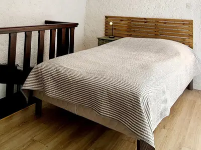 a bed with a white blanket on top of it at Le Marceau Terrasse Sur Le Toit in Narbonne