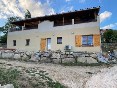 a house on top of a rock wall at Appartement T2 spacieux in Trévillach