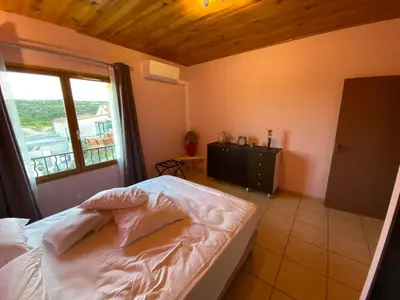 a bedroom with a large bed and a window at Appartement T2 spacieux in Trévillach
