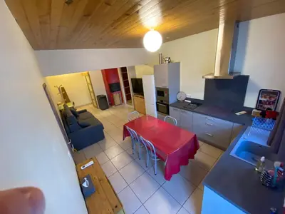 an aerial view of a kitchen and a table in a room at Appartement T2 spacieux in Trévillach