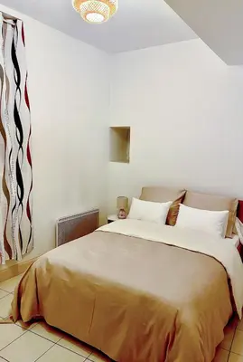a bedroom with a large bed in a room at T3 situé près de la Place Carnot in Carcassone