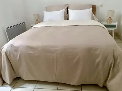 a white bed with white sheets and pillows at T3 situé près de la Place Carnot in Carcassone