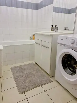 a bathroom with a washing machine and a sink at T3 situé près de la Place Carnot in Carcassone