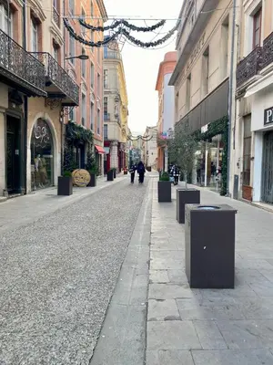 an empty street in a city with buildings at T3 situé près de la Place Carnot in Carcassone
