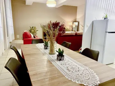 a dining room with a wooden table with chairs at T3 situé près de la Place Carnot in Carcassone