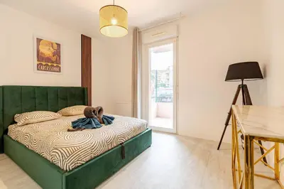 a bedroom with a bed with a teddy bear on it at Le Cosy Bernard , Parking, Piscine, Netflix in Carcassonne