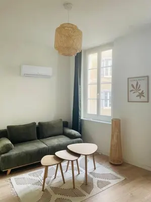 a living room with a couch and two tables at Le Borel I in Castres