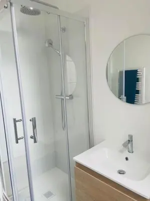 a bathroom with a shower and a sink and a mirror at Le Borel I in Castres
