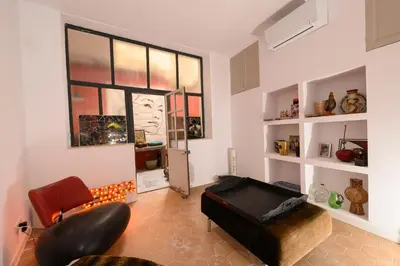 a living room with a couch and a chair at B&B Hugo Puisserguier in Puisserguier