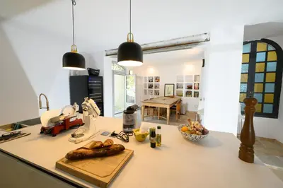 a kitchen with a counter with a table with food on it at B&B Hugo Puisserguier in Puisserguier