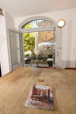 a magazine sitting on top of a wooden table at B&B Hugo Puisserguier in Puisserguier