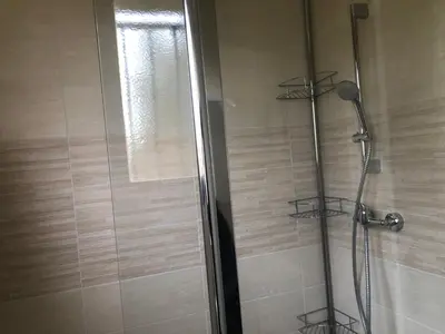 a shower in a bathroom with a glass door at Chez Sophie et Bernard in Saverdun