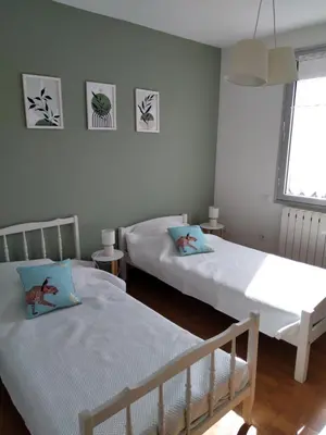 a bedroom with two beds and a window at villa au calme 6 couchages in Trèbes