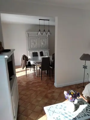 a living room with a table and a white piano at villa au calme 6 couchages in Trèbes