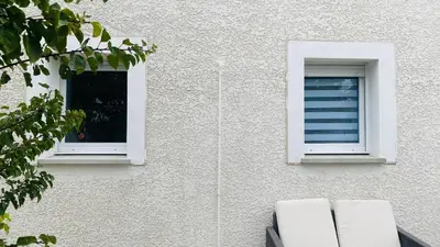 two windows on the side of a building at Maison T3 avec jardin in Narbonne