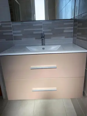 a bathroom with a white sink and a mirror at Maison T3 avec jardin in Narbonne