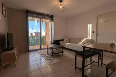 a living room with a couch and a table at T2 Tout Confort - Parking Gratuit in Carcassonne