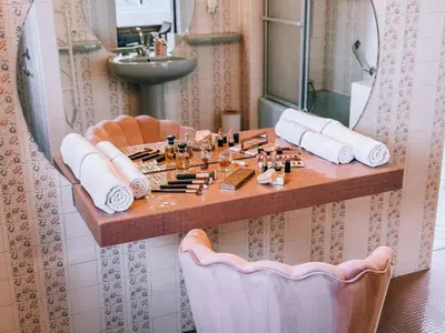 a bathroom with a table with cosmetics on it at LV House & Gardens in Carcassonne