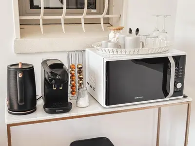 a microwave sitting on top of a counter at LV House & Gardens in Carcassonne