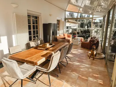 a dining room with a wooden table and chairs at LV House & Gardens in Carcassonne