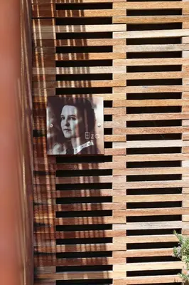 a photograph of a woman looking through a window at Louis Henry in Saint-Pierre-des-Champs