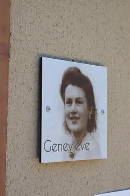 a sign on a wall with a picture of a woman at Louis Henry in Saint-Pierre-des-Champs