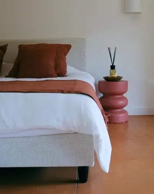 a bedroom with a bed and a vase at Louis Henry in Saint-Pierre-des-Champs