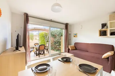 a living room with a couch and a table at Le Clos d'Azille - Appt pour 6 personnes in Azille
