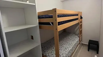 a small room with two bunk beds in it at Le Clos d'Azille - Appt pour 6 personnes in Azille